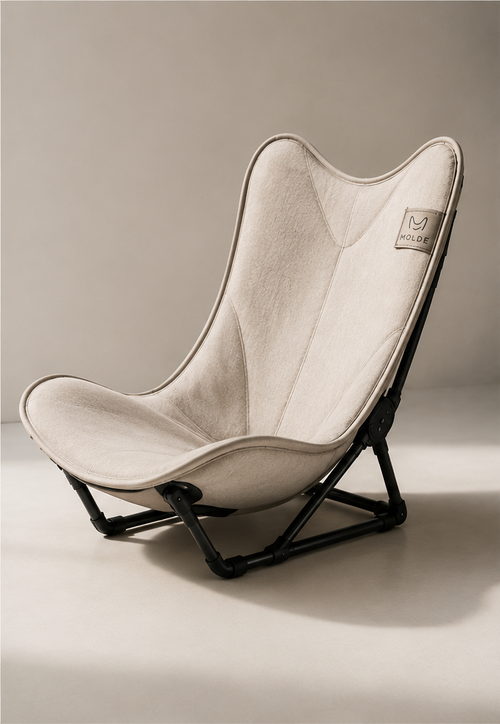 A butterfly-style folding lounge chair shown in multiple views: one large front view, two smaller angled views, a folded view with a carrying strap, and one outdoor view. The chair has a light warm beige fabric seat and back with a black metal frame.